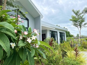 A modern house with a garden in front.