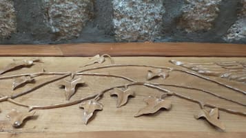 A wooden surface with carved branches and leaves.