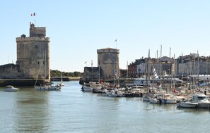 A harbor with boats, a castle, and buildings.