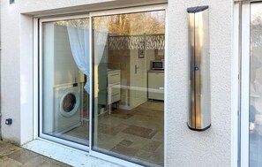 A residential property with a sliding glass door leading to a laundry area and a small kitchen. - Beautiful home in Fondettes with WiFi (Fondettes)