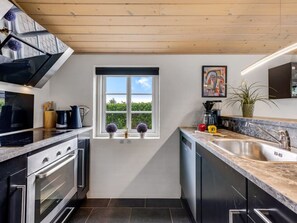 A modern kitchen with a window, stainless steel appliances, and a marble countertop. - "Meindor" - 450m to the fjord by Interhome (Ulfborg)