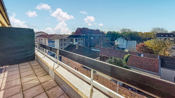 A balcony with a view of residential buildings and a clear sky. - Awesome apartment in Dunkerque (Dunkerque)
