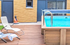 A poolside area with a wooden deck, a hot tub, and lounge chairs. - Lovely home in Jonquerettes (Jonquerettes)