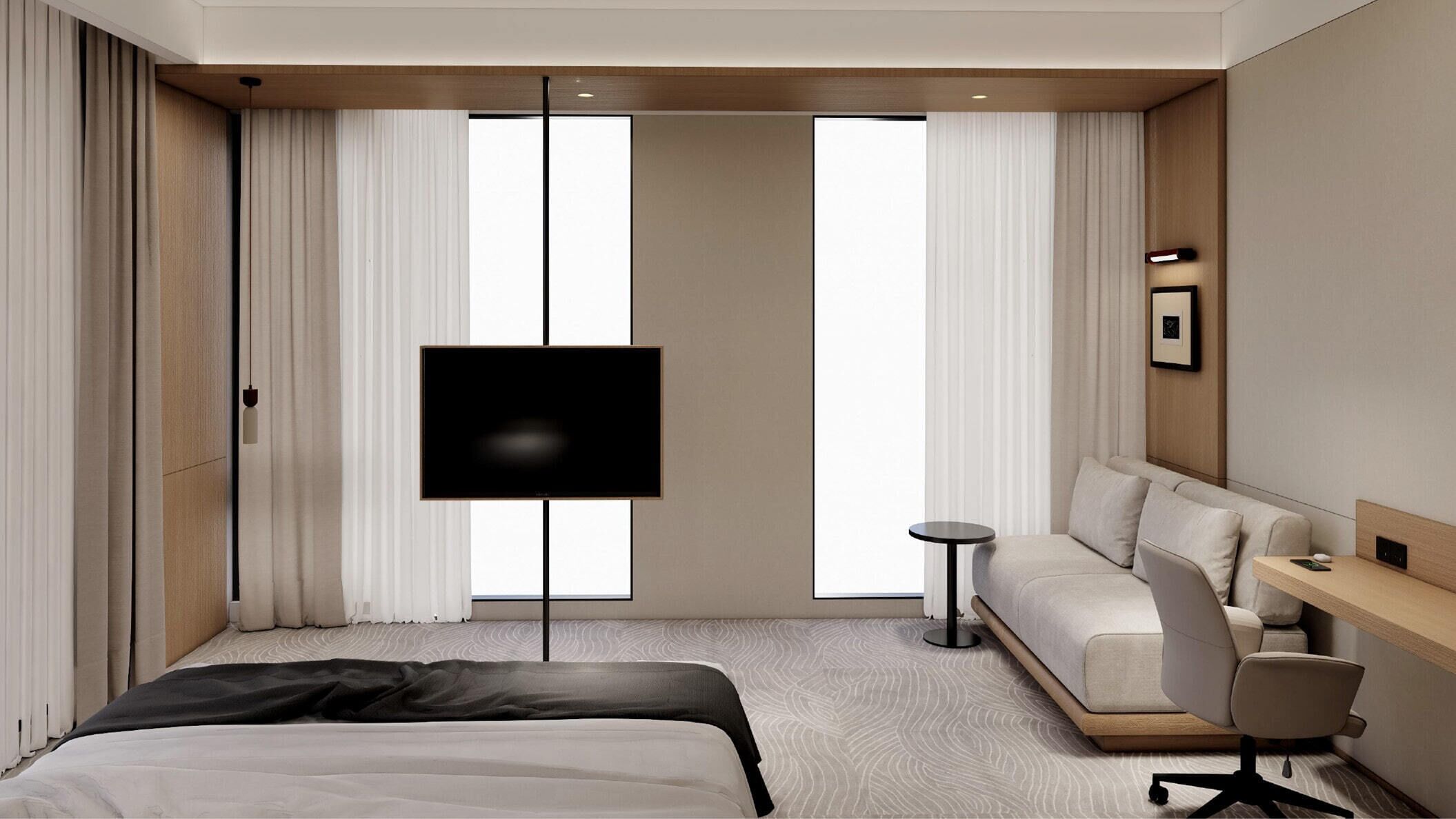 Habitación de hotel moderna con una cama, un sofá, un escritorio, un televisor y una mesita.