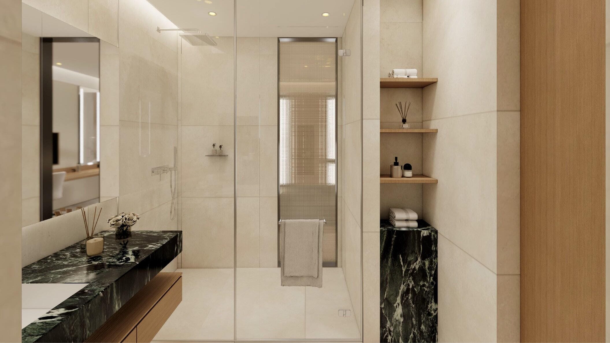 A modern bathroom with a marble vanity, a glass shower enclosure, and built-in shelves with toiletries.
