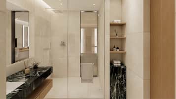 A modern bathroom with a marble vanity, a glass shower enclosure, and built-in shelves with toiletries.
