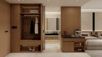 A modern hotel room with a built-in wardrobe, a kitchenette, a bed, and a large mirror.
