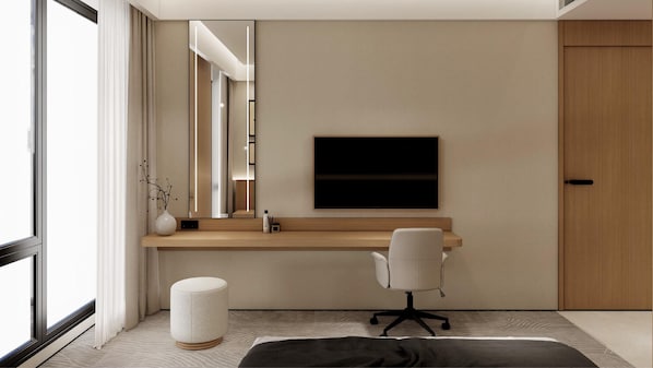 A modern hotel room with a large window, a flat-screen TV mounted on the wall, a wooden desk, a white office chair, and a round ottoman.