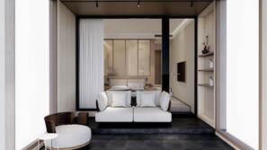 A modern interior with a sofa set, a wicker chair, and a small table. - Manhattan Grand Hotel (Hulhumalé)
