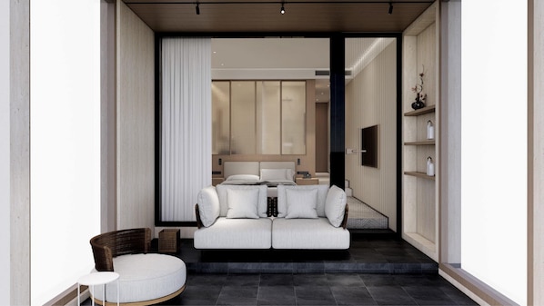 Un interior moderno con un sofá, un sillón de mimbre y una mesita.