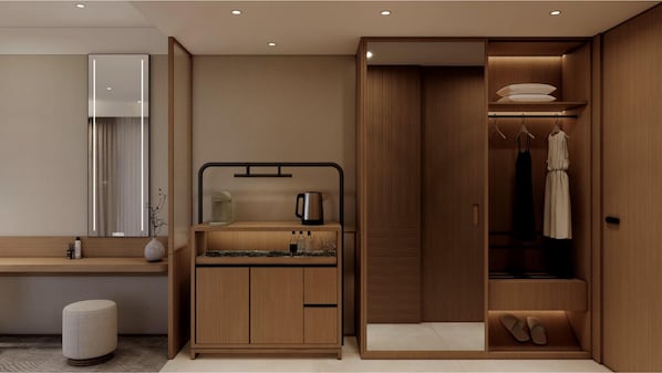 A modern bathroom with a vanity, mirror, and a walk-in closet with hanging clothes and shoes.