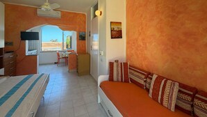 A room with a bed, a desk, a chair, and a window. - Stunning home in Costa Rei with WiFi (Costa Rei)