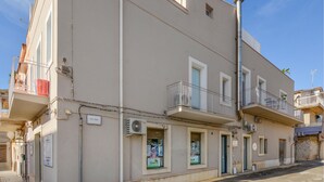 A multi-story building with balconies, air conditioning units, and a sign reading 'VIA FOIS'. - Cozy apartment in Marina di Ragusa with house a panoramic view (Marina di Ragusa)
