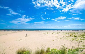 A wide sandy beach with a clear blue sky and scattered clouds. - Cozy apartment in Chioggia with WiFi (Chioggia)