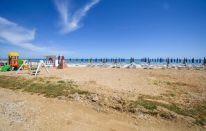 A beach with a children's play area, beach umbrellas, and lounge chairs. - Amazing home in Torino di Sangro with swimming pool (Torino di Sangro)