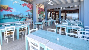 A restaurant with outdoor seating, a mural, and a pool view. - Awesome home in Torino di Sangro with WiFi (Torino di Sangro)