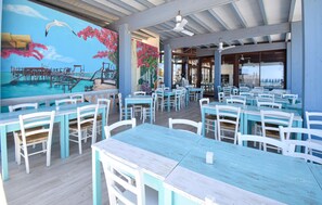 A restaurant with outdoor seating, a mural, and a pool view. - Awesome home in Torino di Sangro with WiFi (Torino di Sangro)