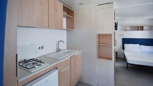 A compact kitchenette with a gas stove, sink, and a white refrigerator. - Awesome home in Torino di Sangro with WiFi (Torino di Sangro)