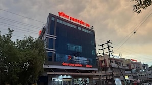 A building with a sign for Seven Star Multispeciality Hospital. - Hotel Skyboat Inn (Nashik)