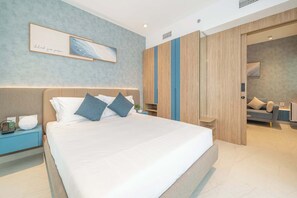 A modern hotel room with a large bed, bedside tables, a wardrobe, and a seating area. - Deluxe Escape  Luxury Wellness Hotel (Jumeirah Village Triangle)