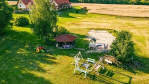 A rural property with a large barn, a play area, and a swing set. - Nice apartment in Przechlewo with sauna (Przechlewo)