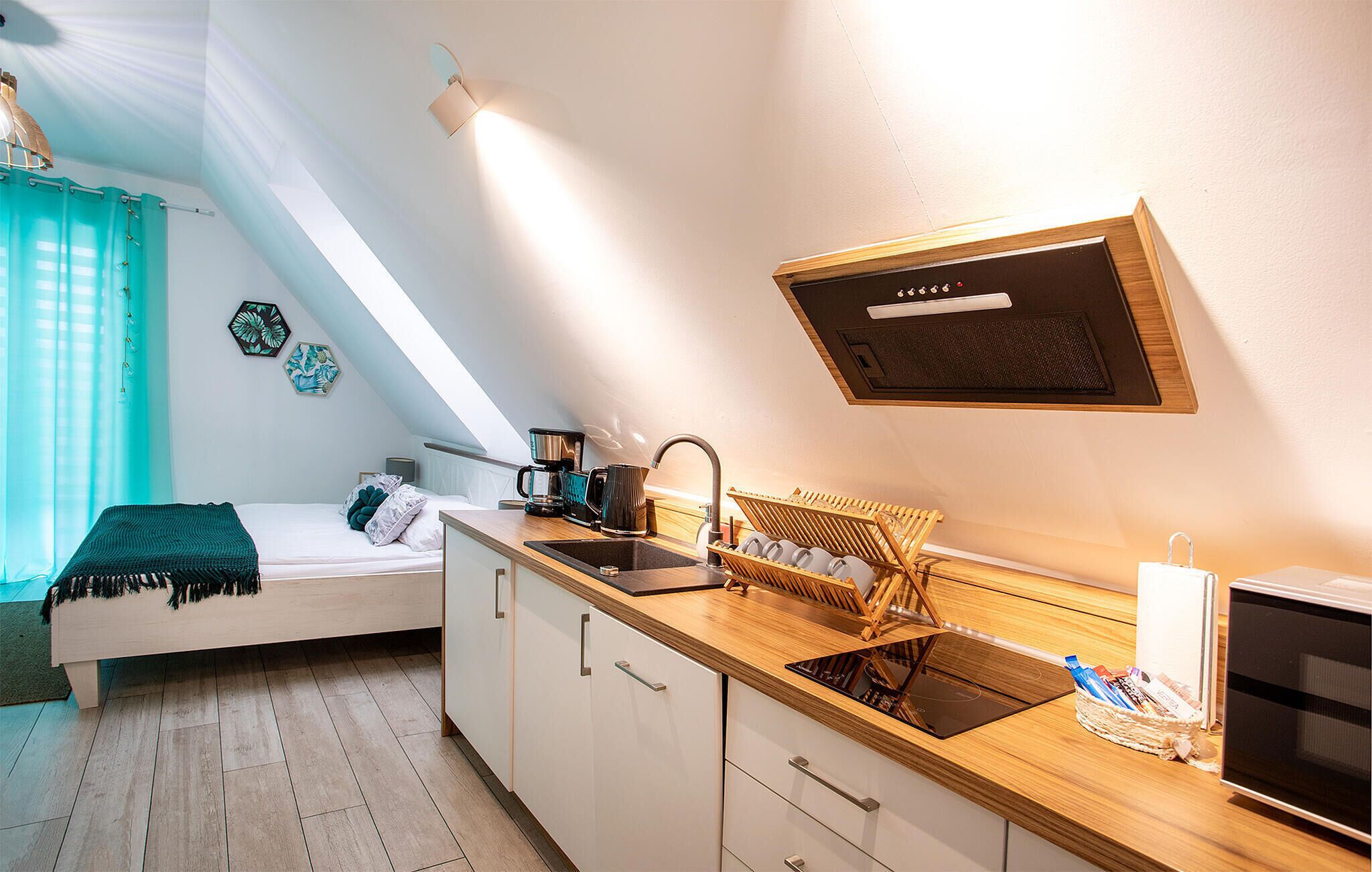 A compact kitchenette with a sink, stove, and a small countertop.