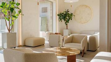A modern living room with a large window, a round coffee table, and a sofa.
