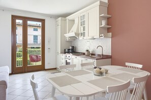 Eine moderne Küche mit weißen Schränken, einem Gasherd und einer Kaffeemaschine.