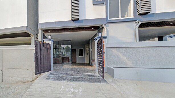 A gated entrance to a building with a concrete pathway leading to a door. - Super Collection O Hyderabad Central (Hyderabad)