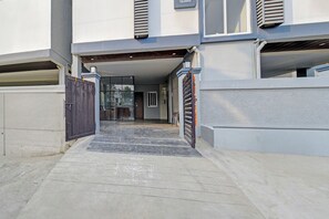 A gated entrance to a building with a concrete pathway leading to a door. - Super Collection O Hyderabad Central (Hyderabad)