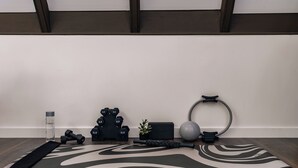 A yoga mat, dumbbells, a water bottle, a plant, a yoga block, and a resistance band on a wooden floor. - Luxury A-Frames - Pet-Friendly - Fenced Yard - Sleeps 12 - Minutes to Greenway! (Asheville)