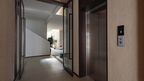 A modern elevator with a digital display and a keypad.