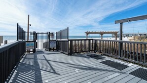 A wooden boardwalk leading to a beach with a clear sky. - Coastal Bliss Beachfront Resort Oasis for 5! (Panama City Beach)