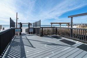 A wooden boardwalk leading to a beach with a clear sky. - Coastal Bliss Beachfront Resort Oasis for 5! (Panama City Beach)