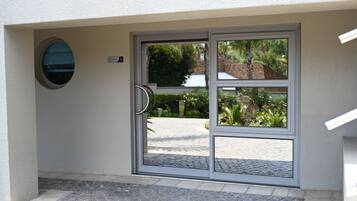 A modern entrance with a glass door, a nameplate, and a small circular window.