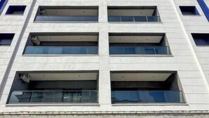 Un edificio de varios pisos con una fachada de ventanas y balcones.