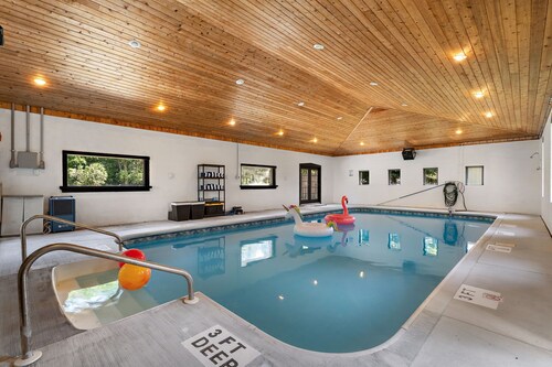 Year-round fun awaits! This pet-friendly retreat sleeps 10 and features 3 king bedrooms, a room with two queens, a heated indoor pool, saltwater hot tub, and TVs with A/C in every bedroom.