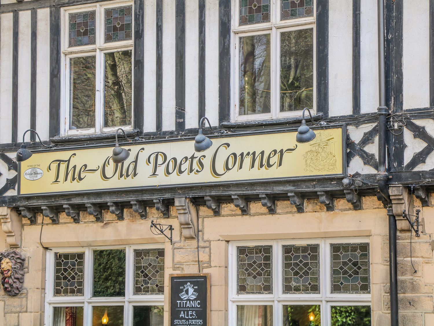 A building with a sign reading 'The Old Poets Corner' and another sign for 'Titanic Ales, Stouts & Porters'.