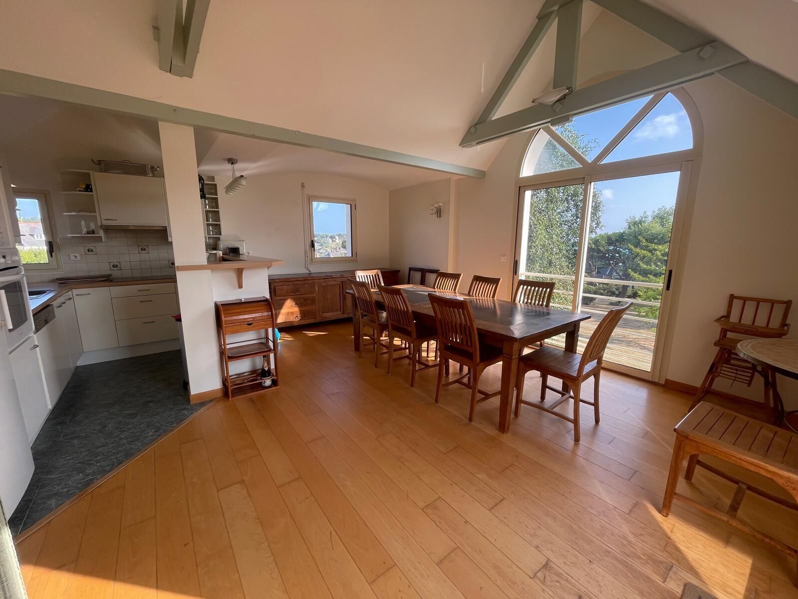 A spacious kitchen with wooden cabinets and a dining area with a large table and chairs.