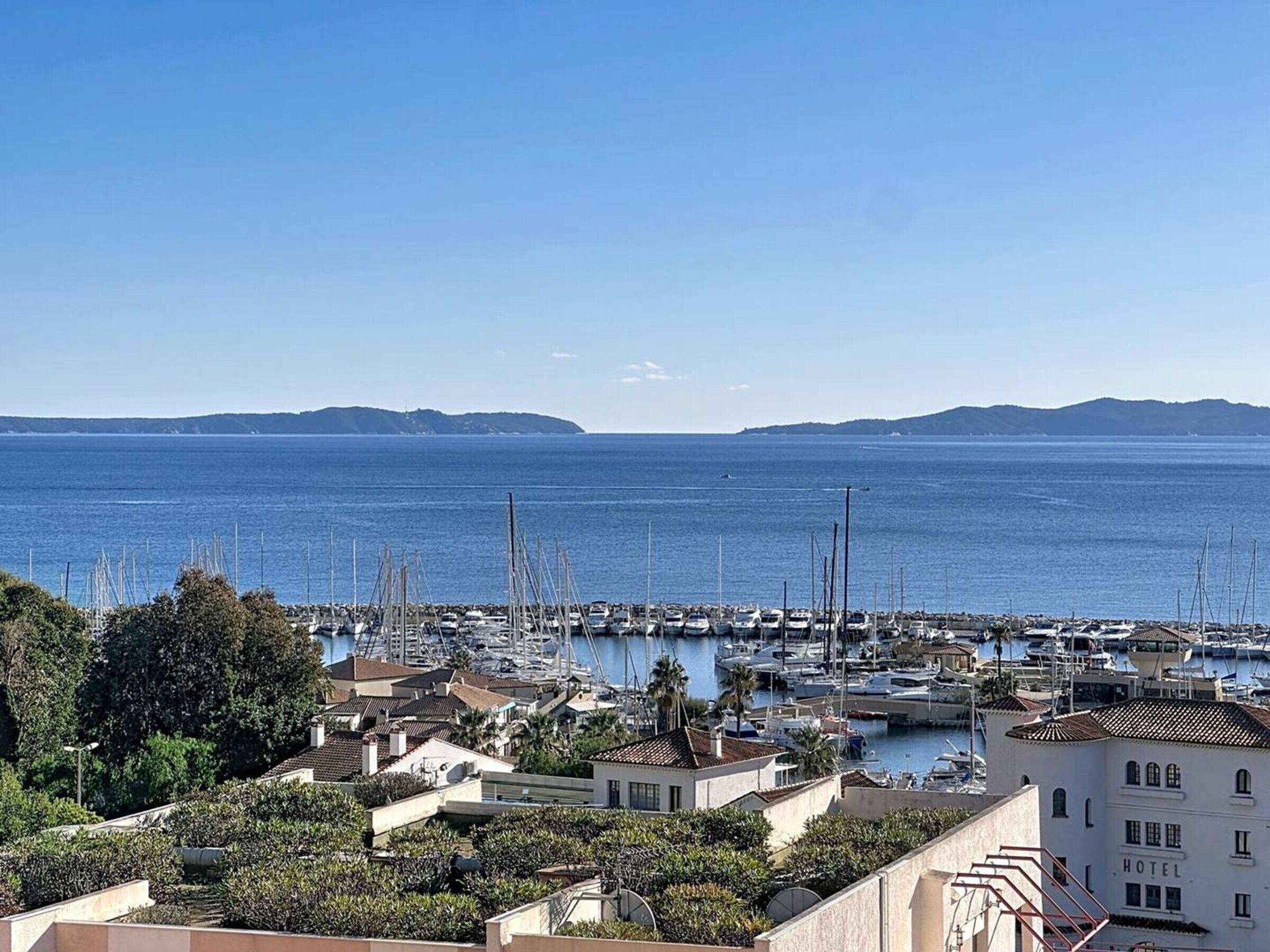 A marina with boats and a hotel in the foreground.