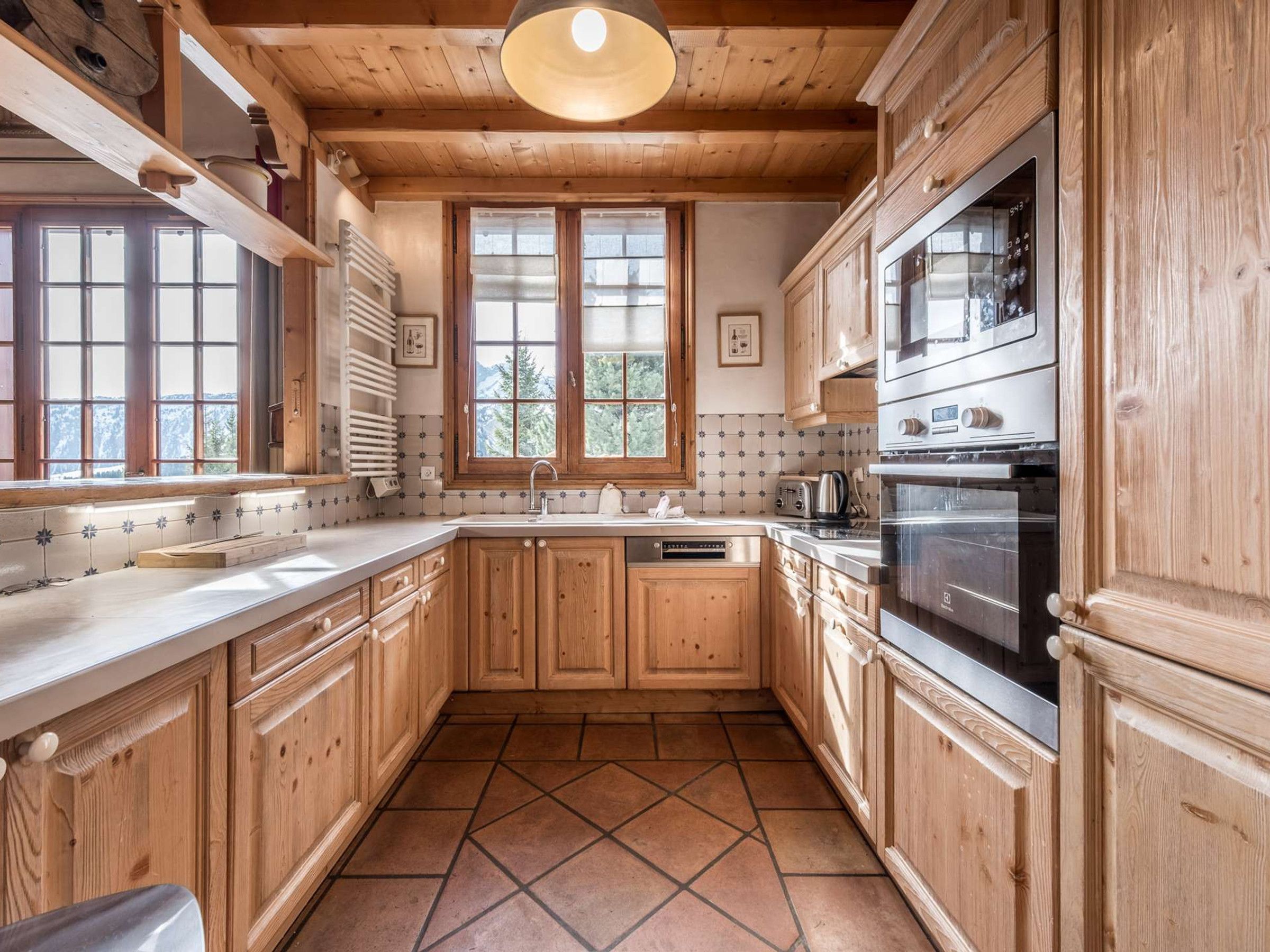 A kitchen with wooden cabinets, a tiled backsplash, and a built-in oven.