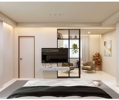 Un dormitorio moderno con una cama, un televisor, una estantería y una silla.