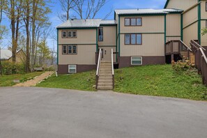 A multi-story building with a central staircase leading to the upper floors. - Three Bedroom condo- 200 yard walk to ski slopes (Sugar Mountain)