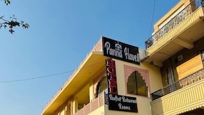 A two-story building with a sign for 'Panna House Rooftop Restaurant' and 'Rooms.' - HOTEL PANNA HAVELI (Amer)