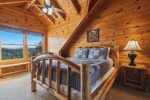 A wooden cabin bedroom with a bed, a window, a ceiling fan, and a framed picture on the wall. - New Listing, Game Room, Theater Room, Free Attractions (Sevierville)