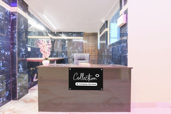 A reception desk with a sign indicating it is company-serviced.