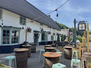 A traditional pub with outdoor seating, wooden barrels, and hanging flower baskets. - The Old Coach House -  Ansty, Dorchester sleeps 4 guests  in 2 bedrooms (Ansty)