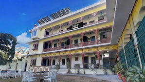 A multi-story building with balconies, solar panels, and outdoor seating. - Super Collection O Mall  (Jaipur)