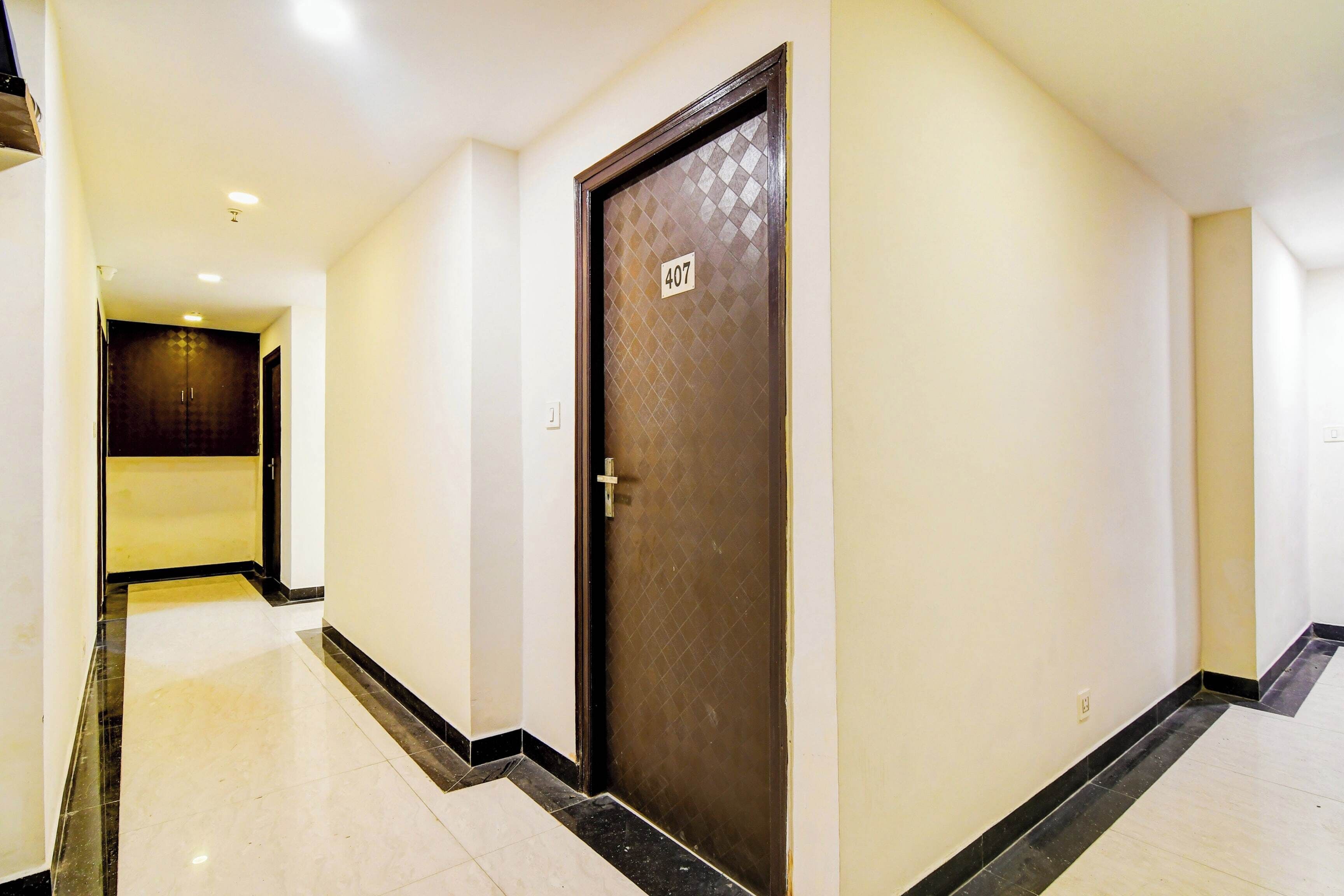 A corridor with a door marked '407' and a hallway leading to another room.