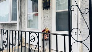 A house with a white exterior, a black metal fence, and a mailbox with the number 2. - Inviting 1BR Apartment — Rockledge Location (Rockledge)